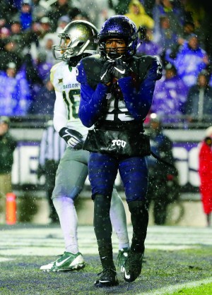 TCU wide receiver KaVontae Turpin holds on tightly to a pass caught in the end zone for a touchdown as Baylor safety Chance Waz (18) stands behind him during the second overtime of an NCAA college football game, Friday, Nov. 27, 2015, in Fort Worth, Texas. TCU won 28-21 in two overtimes. (AP Photo/Tony Gutierrez)