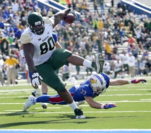 Baylor tight end LaQuan McGowan (80) gets past Kansas safety Michael Glatczak (39) to score a touchdown during the first half of an NCAA college football game Saturday, Oct. 10, 2015, in Lawrence, Kan. (AP Photo/Charlie Riedel)