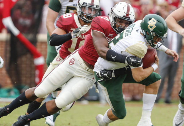 Football fighting to get back up after taking hard hits