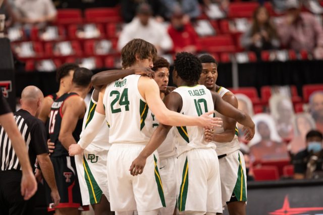 Adam Flagler and his teammates huddle together during Baylor's 68-60 win over Texas Tech on Jan. 16 in Lubbock. Photo by Texas Tech Social Media | Courtesy of Baylor Athletics