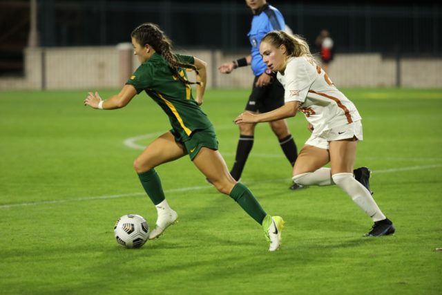 Sophomore midfielder Gabby Muller dribbles past a defender. On Oct. 15, the Baylor Bears fought an intense battle against the Texas Longhorns, resulting in a tie for the two teams.
Audrey La | Photographer