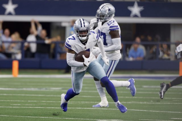 Dallas Cowboys cornerback Trevon Diggs (7) returns an interception as safety Jayron Kearse (27) looks on in the second half of an NFL football game against the Carolina Panthers in Arlington, Texas, Sunday, Oct. 3, 2021. (AP Photo/Ron Jenkins)