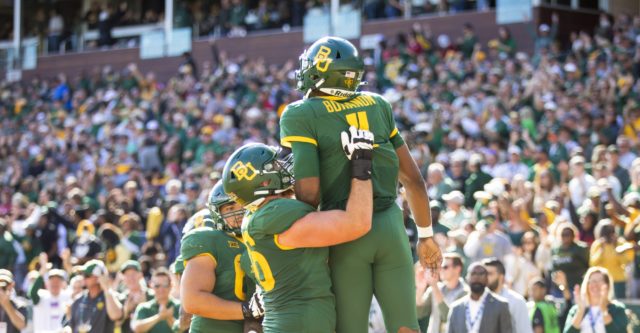 Teammates lift up junior quarterback Gerry Bohanon after a rushing touchdown against the University of Oklahoma on Nov. 13 in McLane Stadium.
Matthew Ellett | Roundup