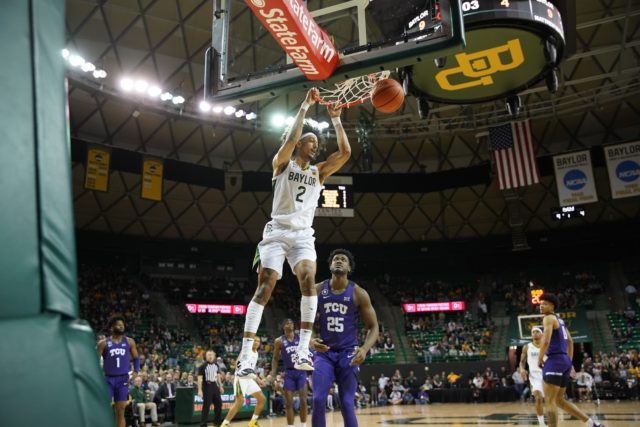 TCU defenders watch as freshman guard, Kendall Brown dunks the ball totaling 13 points, five rebounds and five assists for the game on Feb.19 in the Ferrell Center. 
Josh McSwain | RoundUp
