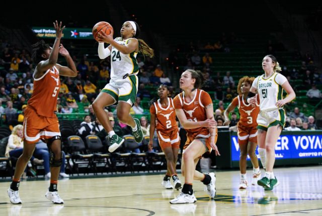 Sophomore guard, Sarah Andrews gets major height, scoring 17 points against the University of Texas on Feb. 4 in the Ferrell Center. Brittany Tankersley | Photo Editor