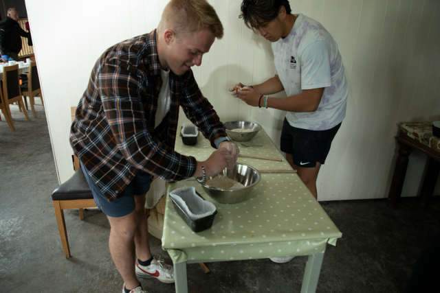 Cavan Burns and Nathan Tran add their ingredients to their bowls before mixing it all together. Photo courtesy of Harper Leigh Roberts
