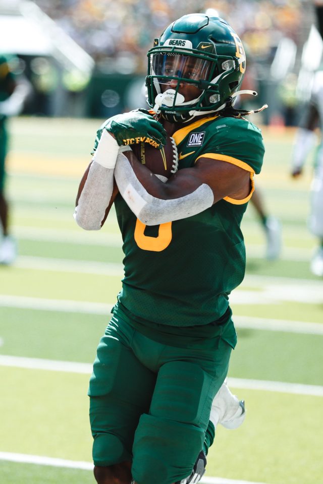 Junior running back Craig "Sqwirl" Williams takes the handoff in pregame drills before the Bears square off against Texas State University on Sept. 17, 2022 at McLane Stadium. Assoah Ndomo | Photographer