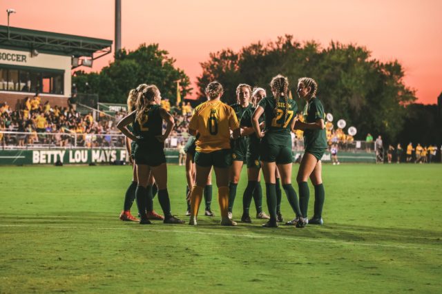The Baylor soccer team huddles and talks over the game plan during its 2-0 loss to the University of Oklahoma on Friday, Sept. 23, 2022 at Betty Lou Mays Field. Assoah Ndomo | Photographer