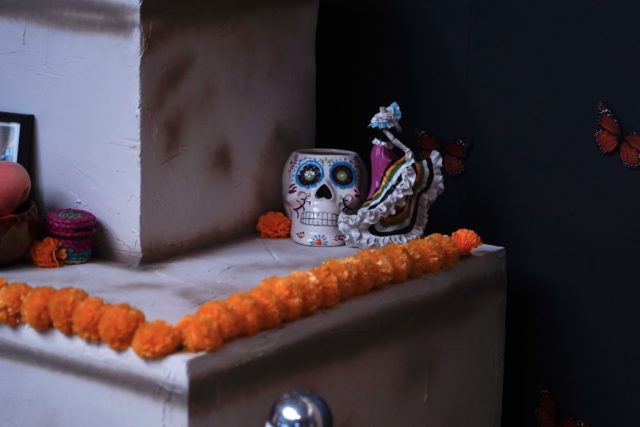 Candy skulls and porcelain dancers bring the ofrenda to life. Grace Everett | Photo Editor