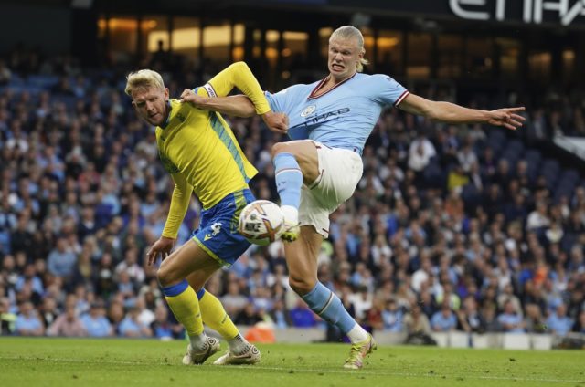 Manchester City's Erling Haaland, right, scores his side's opening goal during the English Premier League soccer match between Manchester City and Nottingham Forest at Etihad Stadium in Manchester, England, Wednesday, Aug 31, 2022. (AP Photo/Dave Thompson)