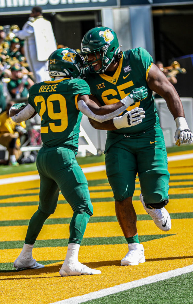 Freshman running back Richard Reese and sixth-year senior offensive lineman Khalil Keith celebrate a touchdown during a conference game against the University of Kansas on Oct. 22, 2022 at McLane Stadium.Kenneth Prabhakar | Photographer