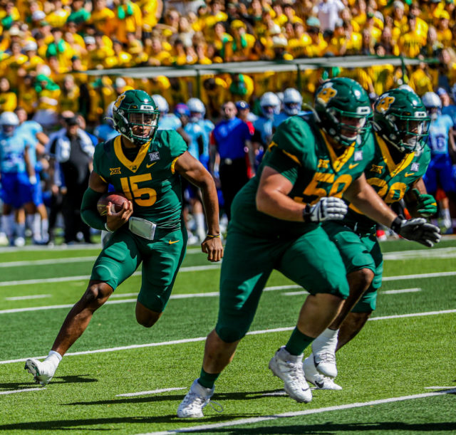 Redshirt freshman backup quarterback Kyron Drones rushes to the right from four yards out for a touchdown in a conference game against the University of Kansas on Oct. 22, 2022 at McLane Stadium.Kenneth Prabhakar | Photographer