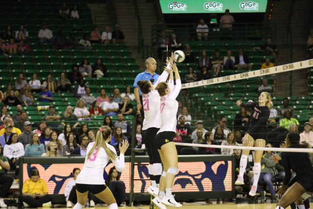 The McGhee sisters block a Texas Tech University kill attempt in a conference match on Oct. 20, 2022 in the Ferrell Center.
Assoah Ndomo | Photographer