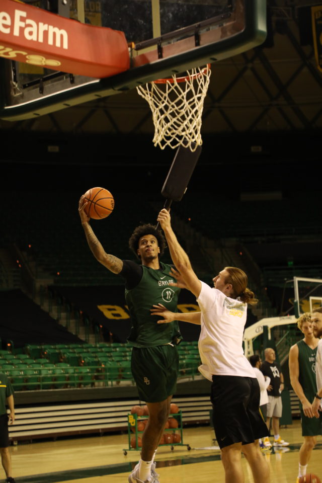 Junior forward Jalen Bridges slices through the lane and fights off contact, finishing a layup at practice on Sept. 27 at the Ferrell Center. Assoah Ndomo | Photograper