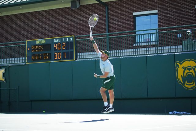 Senior Finn Bass serves the ball to his opponent on Oct. 18, 2022 at the Hurd Tennis Center.
Olivia Havre | Photographer