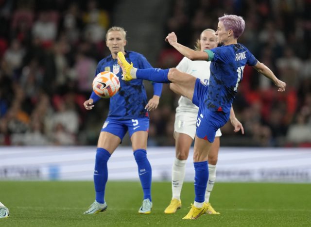 United States' Megan Rapinoe, right, in action during the women's friendly soccer match between England and the US at Wembley stadium in London, Friday, Oct. 7, 2022. (AP Photo/Kirsty Wigglesworth)