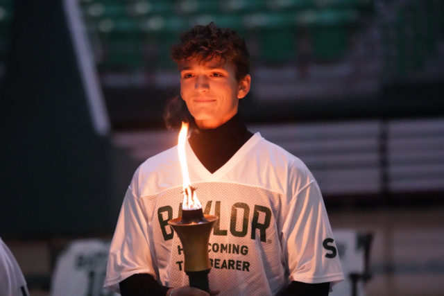 Sophomore student passing the flame to the new freshman class. Grace Everett | Photo Editor
