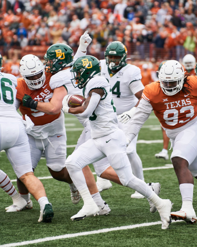 Freshman running back Richard Reese (29) rushes toward the left side of the line of scrimmage during a conference game against No. 23 University of Texas on Nov. 25, 2022 at Darrell K. Royal Memorial Stadium in Austin. 
Josh McSwain | Roundup
