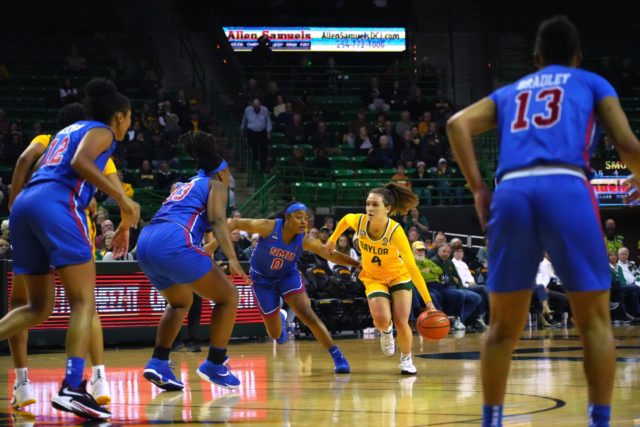 Junior guard Jana Van Gytenbeek (#4) dribbles toward the top of the key with a Southern Methodist University defender on her hip in a non-conference game on Nov. 15, 2022 in the Ferrell Center.
Olivia Havre | Photographer