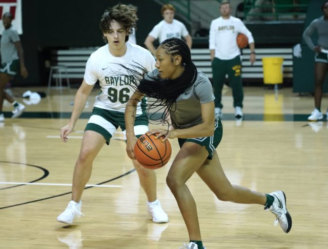 Freshman guard Darianna Littlepage-Buggs dribbles toward the left side of the court during a drill in a team practice on Nov. 2, 2022 in the Ferrell Center.