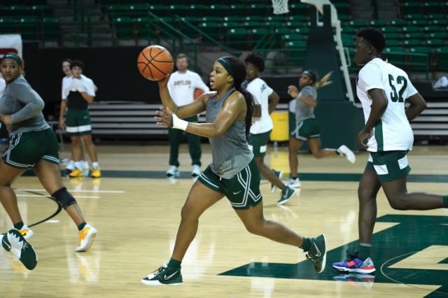 Junior guard Sarah Andrews passes the ball up the court during a team practice on Nov. 2, 2022 in the Ferrell Center. 
Grace Everett | Photo Editor