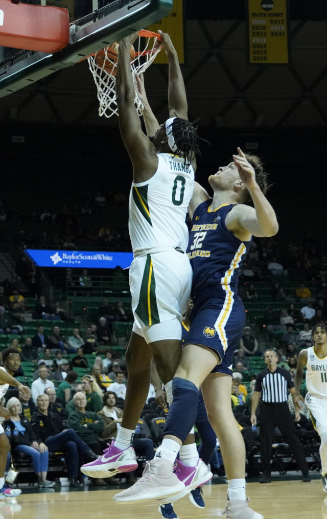 Fifth-year senior forward Flo Thamba posterizes a University of Northern Colorado defender in a non-conference game on Nov. 14, 2022 in the Ferrell Center.
Grace Everett | Photo Editor