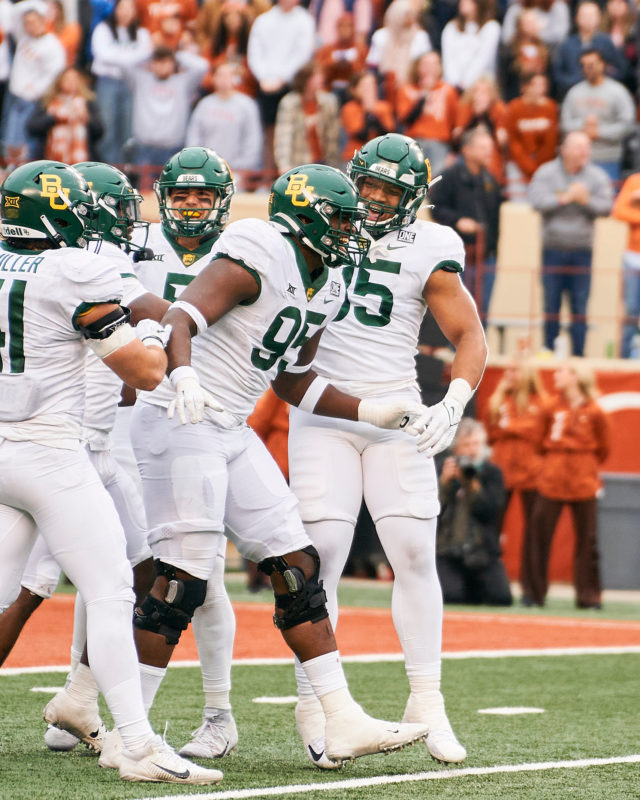 Junior defensive lineman Gabe Hall (95) and the Baylor defense celebrate a big play during a conference game against No. 23 University of Texas on Nov. 25, 2022 at Darrell K. Royal Memorial Stadium in Austin. 
Josh McSwain | Roundup