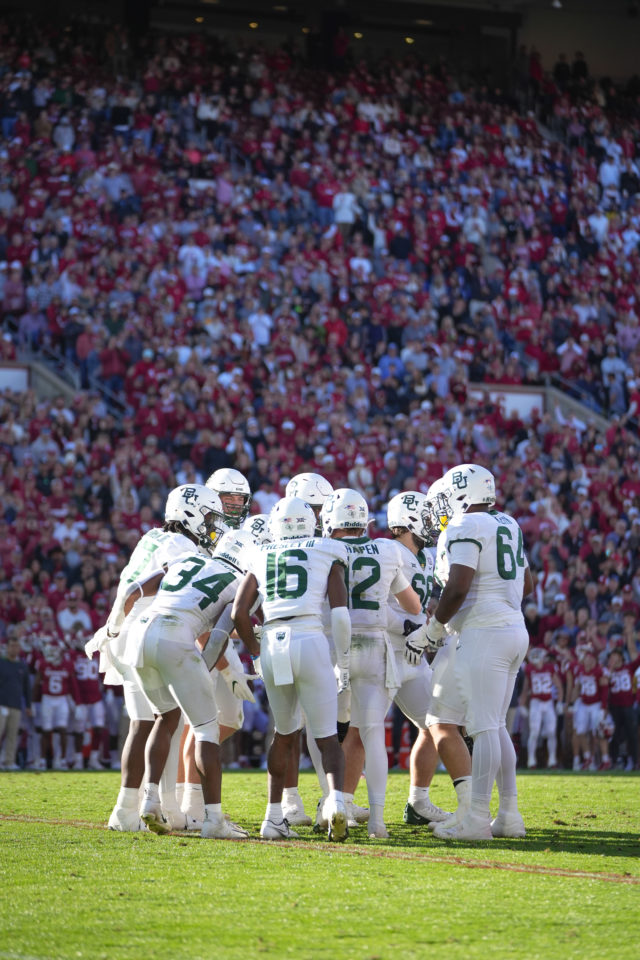 The Baylor football offense huddles before a play during a conference contest against the University of Oklahoma on Nov. 5, 2022 at Gaylord Family Oklahoma Memorial Stadium in Norman, Okla. 
Josh Wilson | Roundup Photo Editor