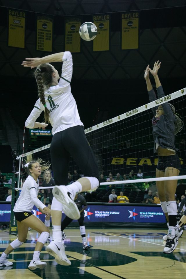 Fifth-year senior middle blocker Mallory Talbert jumps to kill the ball following a set by a teammate during a conference match against the University of Oklahoma on Oct. 5, 2022 at the Ferrell Center.
Katy Mae Turner | Photographer