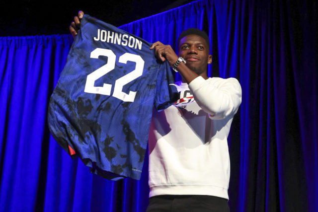 Sean Johnson holds up his jersey Wednesday, Nov. 9, 2022, in New York, after being introduced as one of the goalkeepers on the U.S. men's national soccer team for the upcoming World Cup in Qatar, (AP Photo/Julia Nikhinson)
