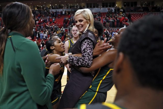 Former Baylor women's basketball head coach Kim Mulkey celebrates with her team following a win.
Associated Press