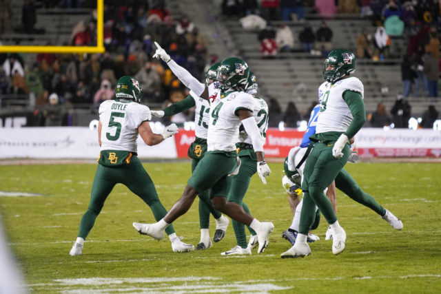 Fifth-year senior safety Christian Morgan (4) and some other members of Baylor's defense celebrates a crucial stop during the Lockheed Martin Armed Forces Bowl on Dec. 22, 2022 at Amon G. Carter Stadium in Fort Worth. Josh Wilson | Roundup