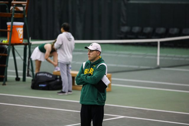 Head coach Joey Scrivano looks across the courts as his squad competes in singles play against the University of Texas Rio Grande Valley on Jan. 21, 2023, in the Hawkins Indoor Tennis Center
Kenneth Prabhakar | Photo Editor