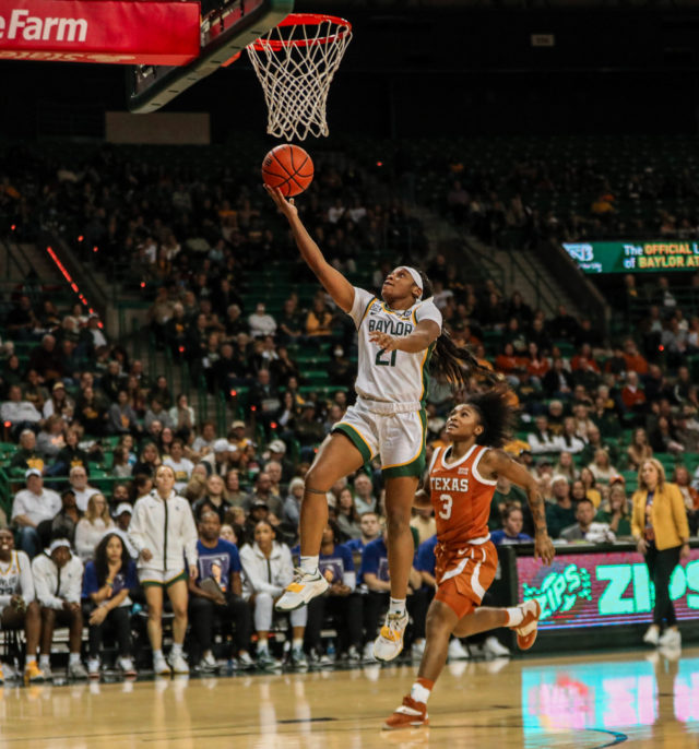 Graduate student guard Ja'Mee Asberry (21) soars up for a right-handed layup on a fast break during a conference game against No. 25 University of Texas on Feb. 22, 2023 in the Ferrell Center. 
Kenneth Prabhakar | Photo Editor