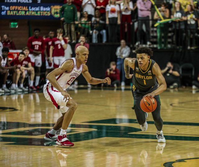 Freshman guard Keyonte George (1) dribbles past a Razorback defender during a Big 12/SEC Challenge game against the University of Arkansas on Jan. 28, 2023 in the Ferrell Center.
Kenneth Prabhakar | Photo Editor