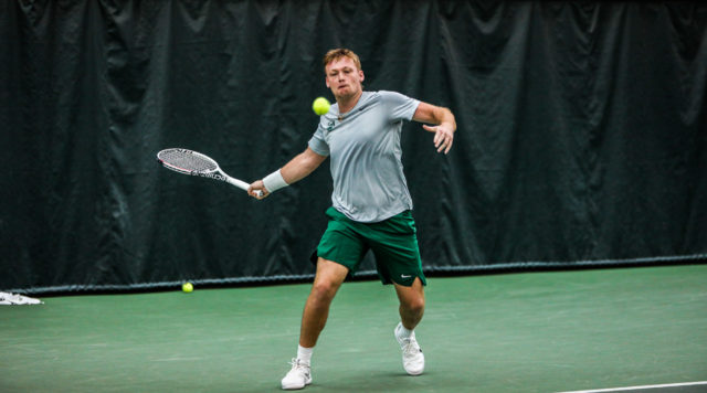 Senior Finn Bass winds up for a return shot during a second round match in the ITA Kickoff Weekend against No.  9 Florida State University on Jan.  28, 2023 in the Hawkins Indoor Tennis Center.  Kenneth Prabhakar  Photo Editor