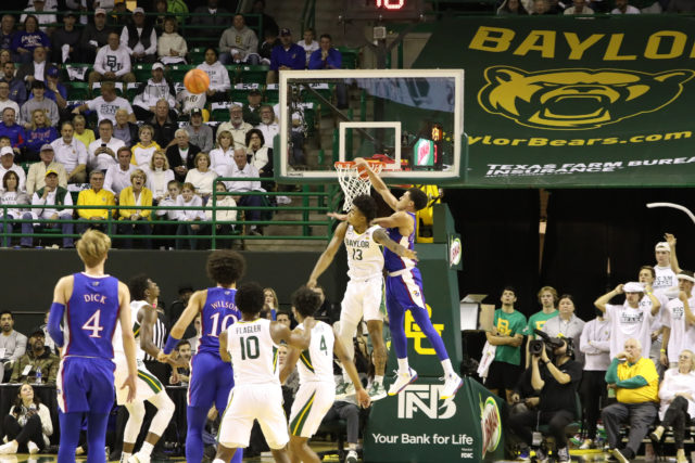 Redshirt freshman guard Langston Love (13) sniffs out an alley-oop attempt and blocks it away during a conference game against No. 9 University of Kansas on Jan. 23, 2023, in the Ferrell Center. 
Assoah Ndomo | Photographer
