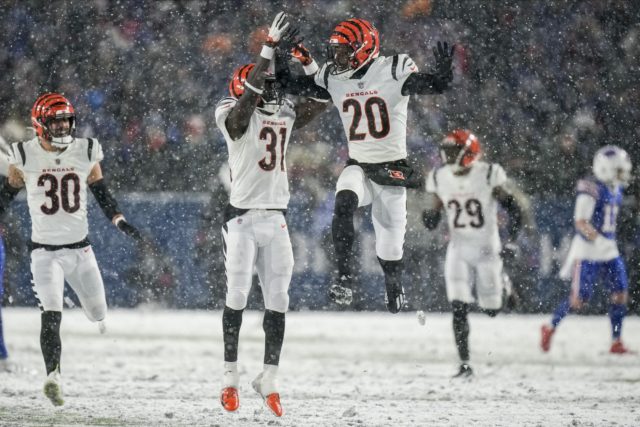 Cincinnati Bengals safety Michael Thomas (31) and Cincinnati Bengals cornerback Eli Apple (20) react after a defensive play against the Buffalo Bills during the fourth quarter of an NFL division round football game Sunday in Orchard Park, N.Y. (AP Photo/Seth Wenig)