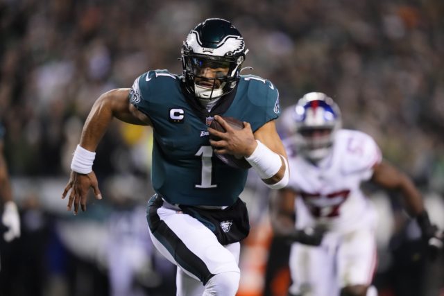 Philadelphia Eagles quarterback Jalen Hurts runs for a touchdown against the New York Giants during the first half of an NFL divisional round playoff football game, Saturday, Jan. 21, in Philadelphia. (AP Photo/Matt Rourke)