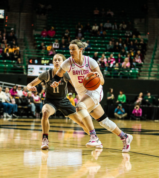 Fifth-year senior forward Caitlin Bickle (51) pushes her way toward the basket after losing her defender on the perimeter during a conference game against No. 22 Iowa State University, Saturday, Feb. 18, 2023, in the Ferrell Center.
Kenneth Prabhakar | Photo Editor