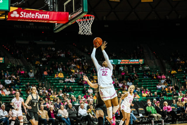 Freshman forward Bella Fontleroy (22) scores a layup under the basket during a conference game against No. 22 Iowa State University, Saturday, Feb. 18, 2023, in the Ferrell Center.
Kenneth Prabhakar | Photo Editor