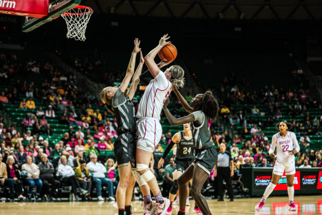 Fifth-year senior forward Caitlin Bickle (51) shoots over two Cyclone defenders during a conference game against No. 22 Iowa State University, Saturday, Feb. 18, 2023, in the Ferrell Center.
Kenneth Prabhakar | Photo Editor