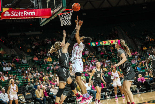 Freshman forward Darianna Littlepage-Buggs (5) shoots a layup over a Cyclone defender during a conference game against No. 22 Iowa State University, Saturday, Feb. 18, 2023, in the Ferrell Center.
Kenneth Prabhakar | Photo Editor