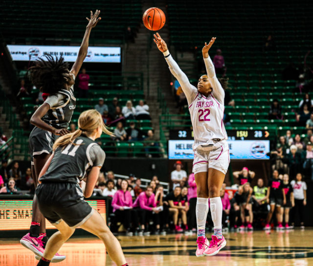 Freshman forward Bella Fontleroy (22) shoots a 3-pointer from the top of the key during a conference game against No. 22 Iowa State University, Saturday, Feb. 18, 2023, in the Ferrell Center.
Kenneth Prabhakar | Photo Editor
