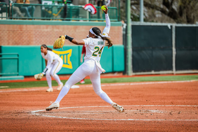 Junior right-handed pitcher Dariana Orme (24) whips forward and slings her pitch toward the catcher during a game against No. 1 University of Oklahoma as part of the Getterman Classic, Sunday, Feb. 19, 2023, at Getterman Stadium.
Kenneth Prabhakar | Photo Editor