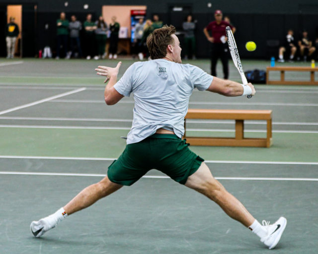 Senior Finn Bass extends for a tough return shot during singles play of a a non-conference match against No. 9 Florida State University on Jan. 28, 2023 in the Hawkins Indoor Tennis Center. 
Kenneth Prabhakar | Photo Editor