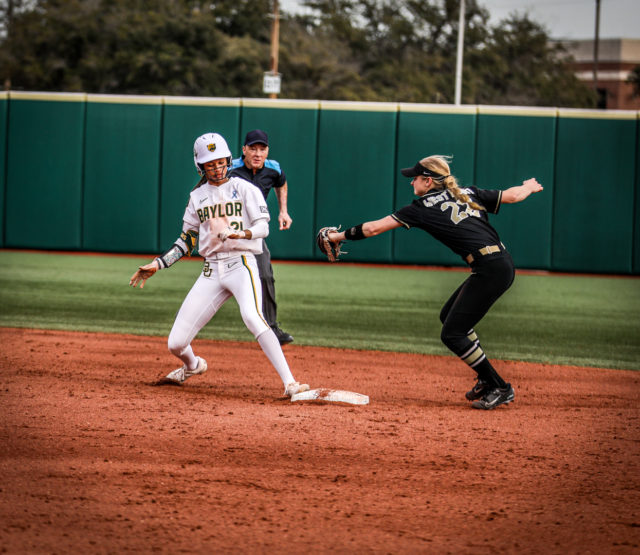 Junior outfielder McKenzie Wilson (21) scampers back to the second base bag and avoids being tagged out during the final game of the Getterman Classic against the United States Military Academy, Sunday, Feb. 19, 2023, at Getterman Stadium. 
Kenneth Prabhakar | Photo Editor