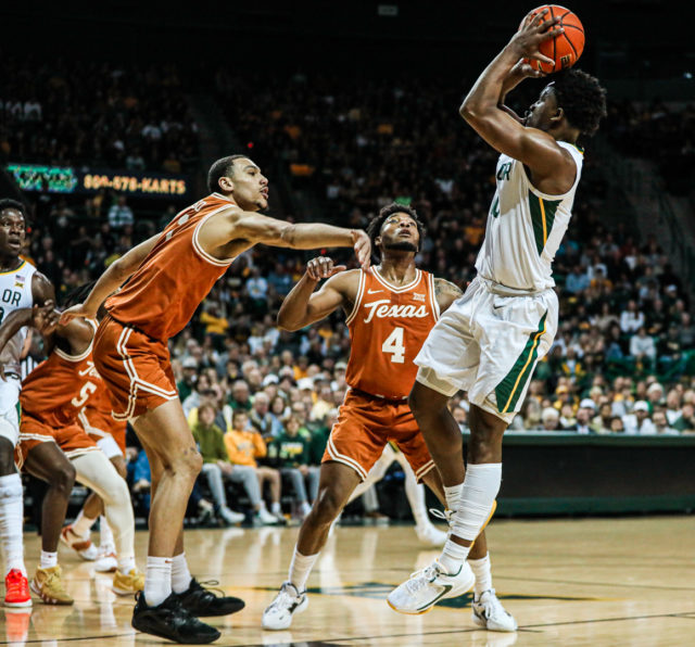 Redshirt senior guard Adam Flagler (10) stops and pops a fadeaway shot during a conference game against No. 8 University of Texas, Saturday, Feb. 25, 2023, in the Ferrell Center.Kenneth Prabhakar | Photo Editor