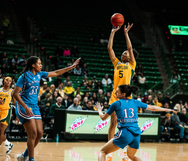 Freshman forward Darianna Littlepage-Buggs (5) shoots a mid-range jumpshot from the top of the key during a conference game against the University of Kansas on Feb. 1, 2023 in the Ferrell Center.
Kenneth Prabhakar | Photo Editor