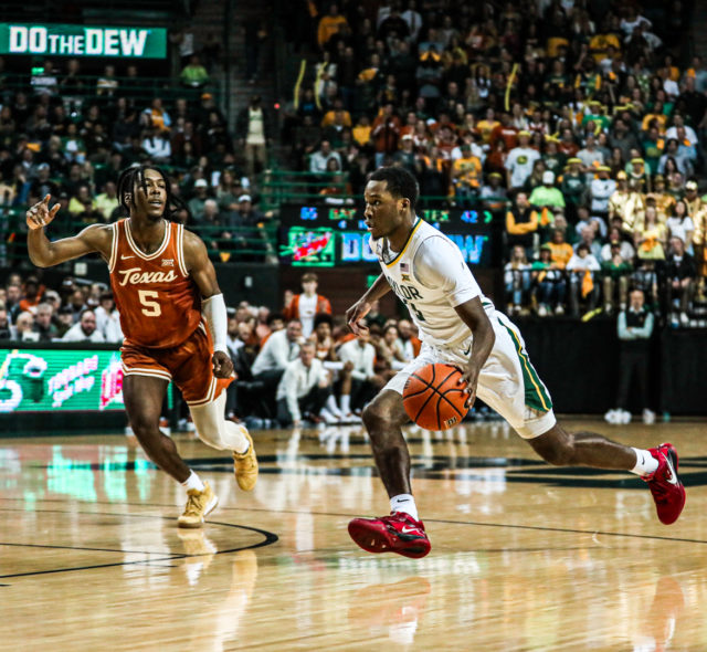 Redshirt senior guard Dale Bonner (3) gathers the ball and drives toward the basket during a conference game against No. 8 University of Texas, Saturday, Feb. 25, 2023, in the Ferrell Center.Kenneth Prabhakar | Photo Editor